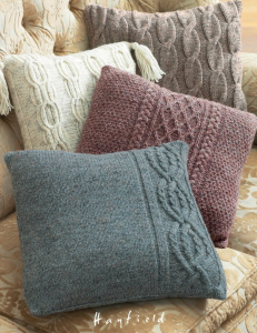 Four cushions with various cable knit designs