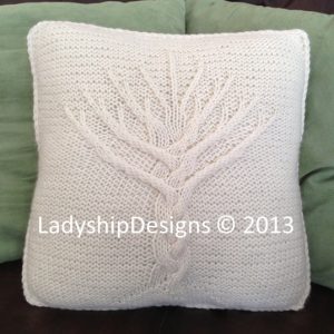 Cable tree of life design on a knit pillow