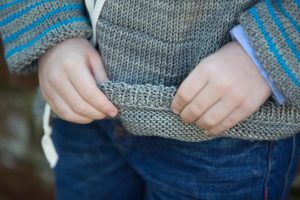 Built-to-let-out hem on a knit sweater for kids