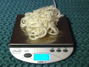 Cream colored mystery yarn on a digital scale