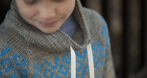 Geometric stranded colorwork on knit sweater yoke