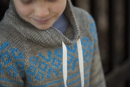 Geometric stranded colorwork on knit sweater yoke